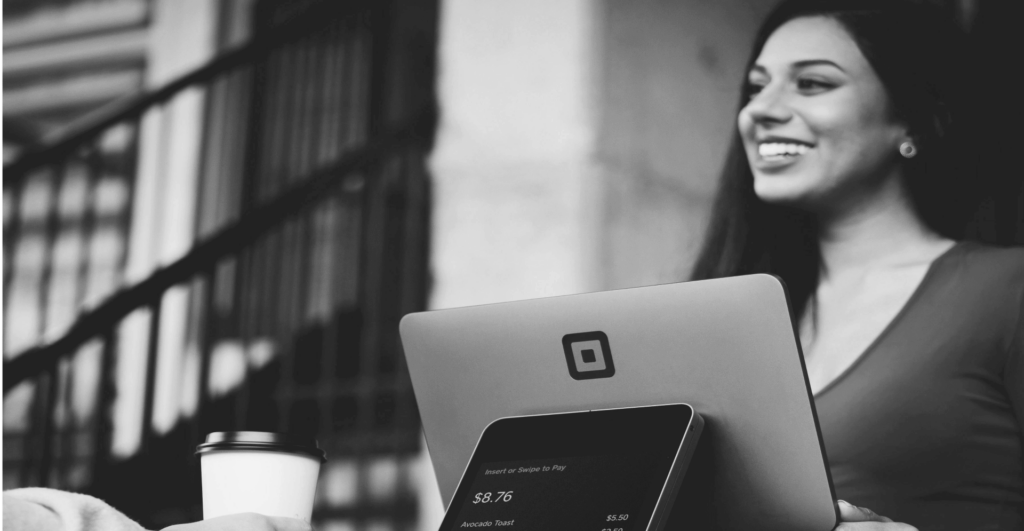 This image of a lady checking out at a cash register illustrates our discussion topic: scam surges during the Black Friday Sales, and how brands can protect themselves, their consumers, and their revenues.