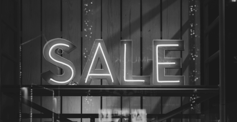 This image of a sale sign in a retail store illustrates our discussion topic: scam surges during the Black Friday Sales, and how brands can protect themselves, their consumers, and their revenues.