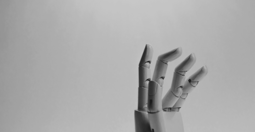 This image of a spooky robot hand illustrates our discussion topic: A phishing email, and other cyberthreats, affecting US industries like finance and pharmaceuticals.