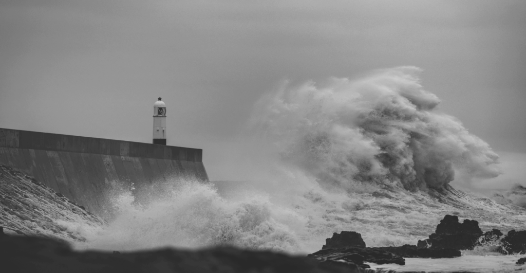 This image of waves crashing on a lighthouse illustrates the tempestuous nature of brand threats in this brand protection guide.