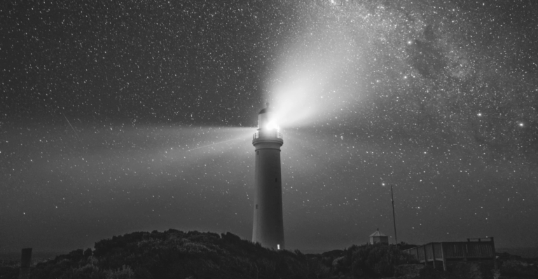 This image of a lighthouse in front of a stary sky illustrates the the boundless potential of brand protection in this protection guide.