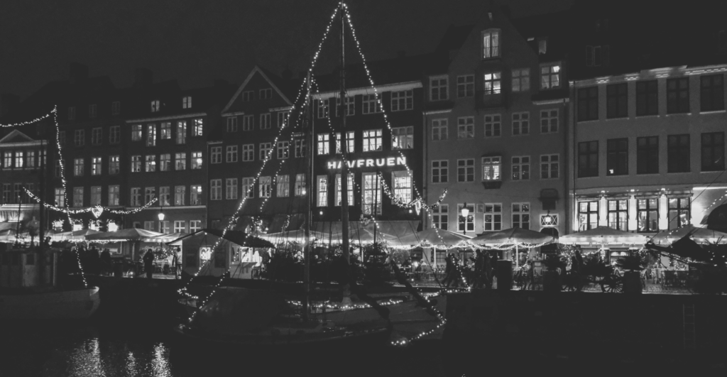 This image of festive lights adorning a ships in a Danish harbour illustrates our discussion topic: Christmas celebrations, and brand protection strategies, around the world.
