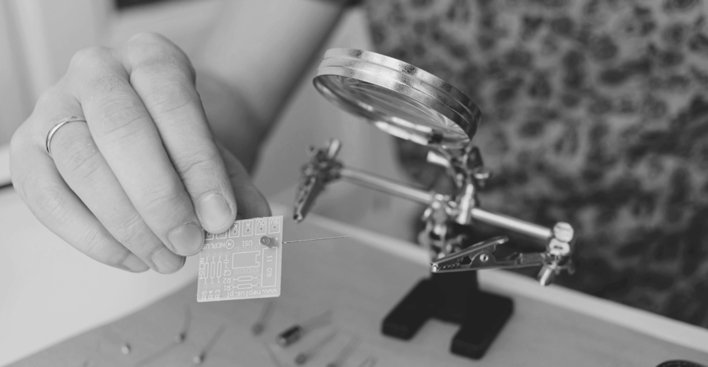 This image of someone looking at a circuit through a magnifying glass illustrates our discussion topic: AI, the practical applications for brand protection, and EBRAND's new DeepVision tools.