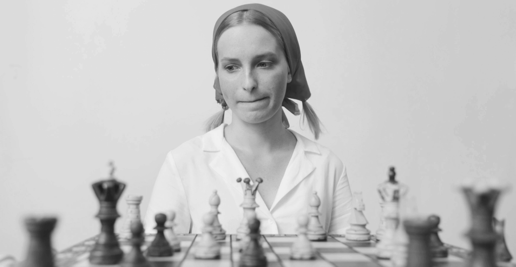 This image of a chess player in Soviet-style dress illustrates our discussion topic: .su websites, their relevance to your domain cyberthreat landscape, and strategies for protecting yourself and your team.