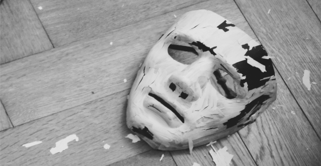 This image of a broken mask on the floor illustrates our discussion topic: generative ai and brand protection.