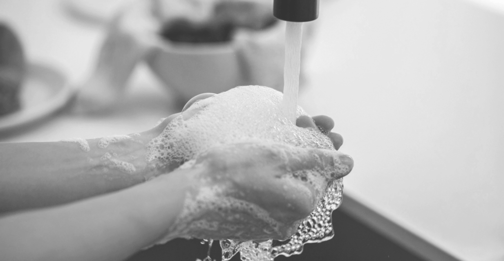 This image of someone washing their hands at a sink highlights our discussion topic: Cyber hygiene, how businesses undervalue it, and its potential for digital risk protection.