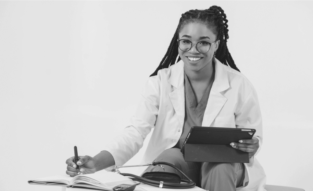 This image of a smiling healthcare professional with a smart tablet computer highlights our discussion topic: Cyber hygiene, how businesses undervalue it, and its potential for digital risk protection.