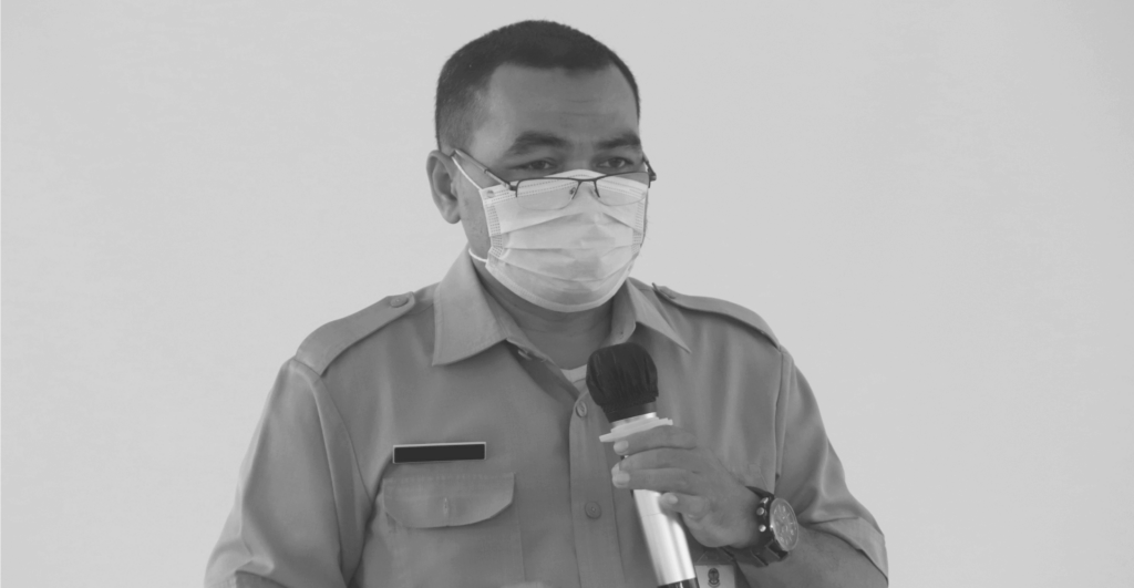 This image of a masked health professional giving a speech into a microphone illustrates our discussion topic: counterfeit health products, their impact on consumers, and the role of brands in fighting back.