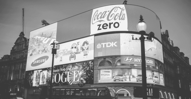 This image of an advertisement hoarding in a busy city square illustrates our discussion topic: Fake and infringing ads, and PPC brand protection solutions.
